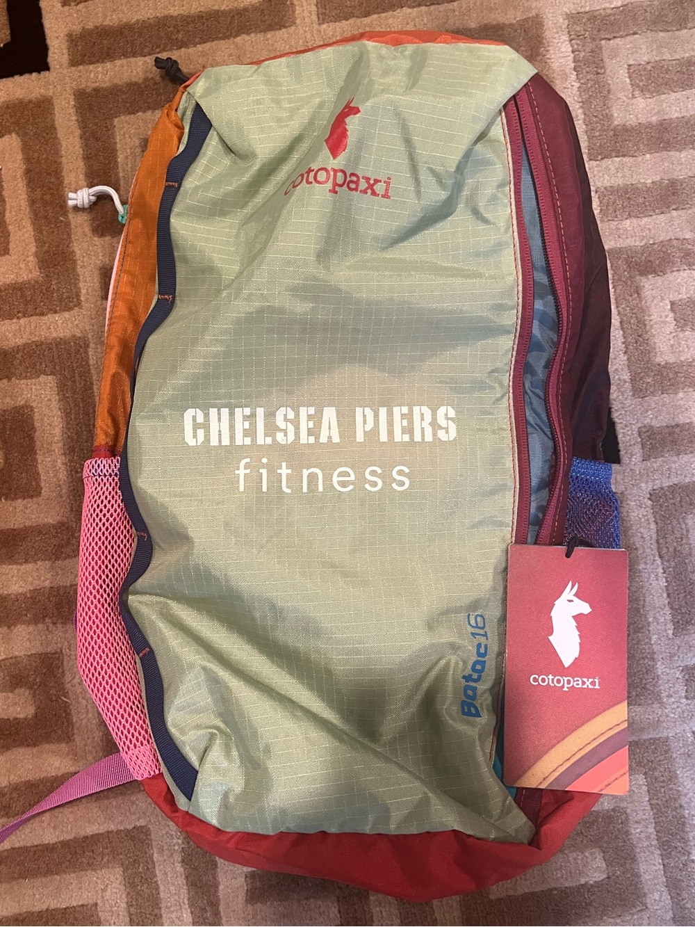 cotopaxi Chelsea Piers fitness pack in green, red, orange, pink
